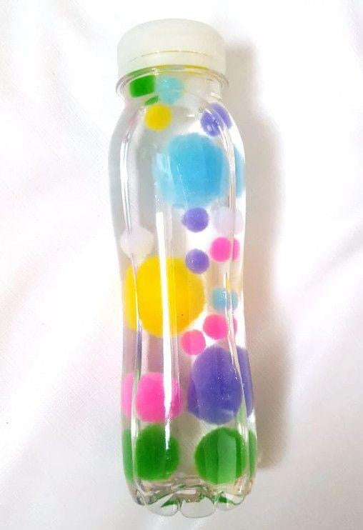 Botella sensorial de pompones
